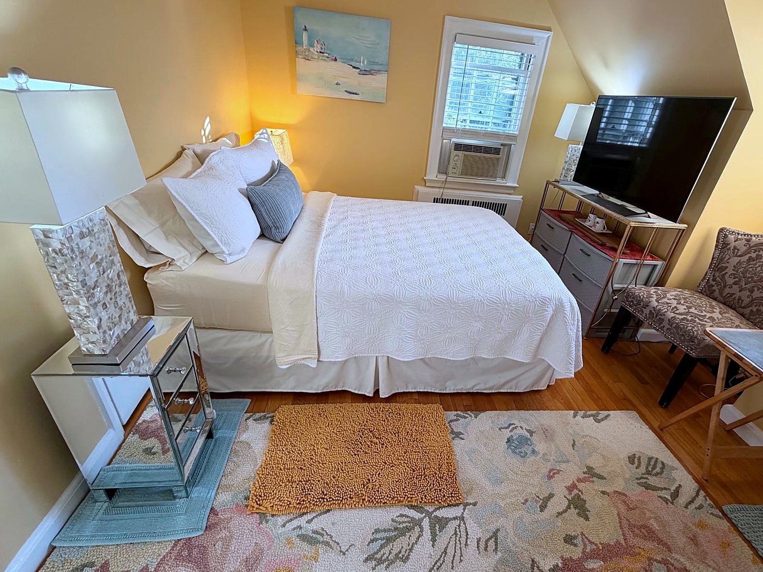 The English Garden Room's seating area and television at this Wellesley bed and breakfast